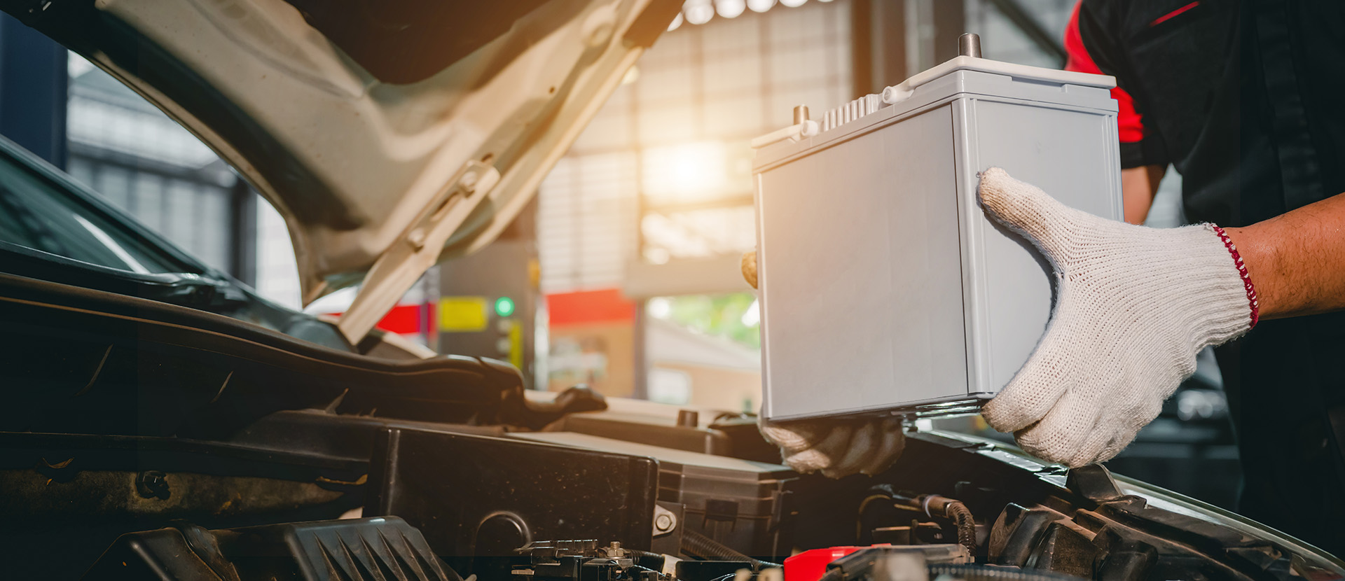 Mechanic replacing car battery