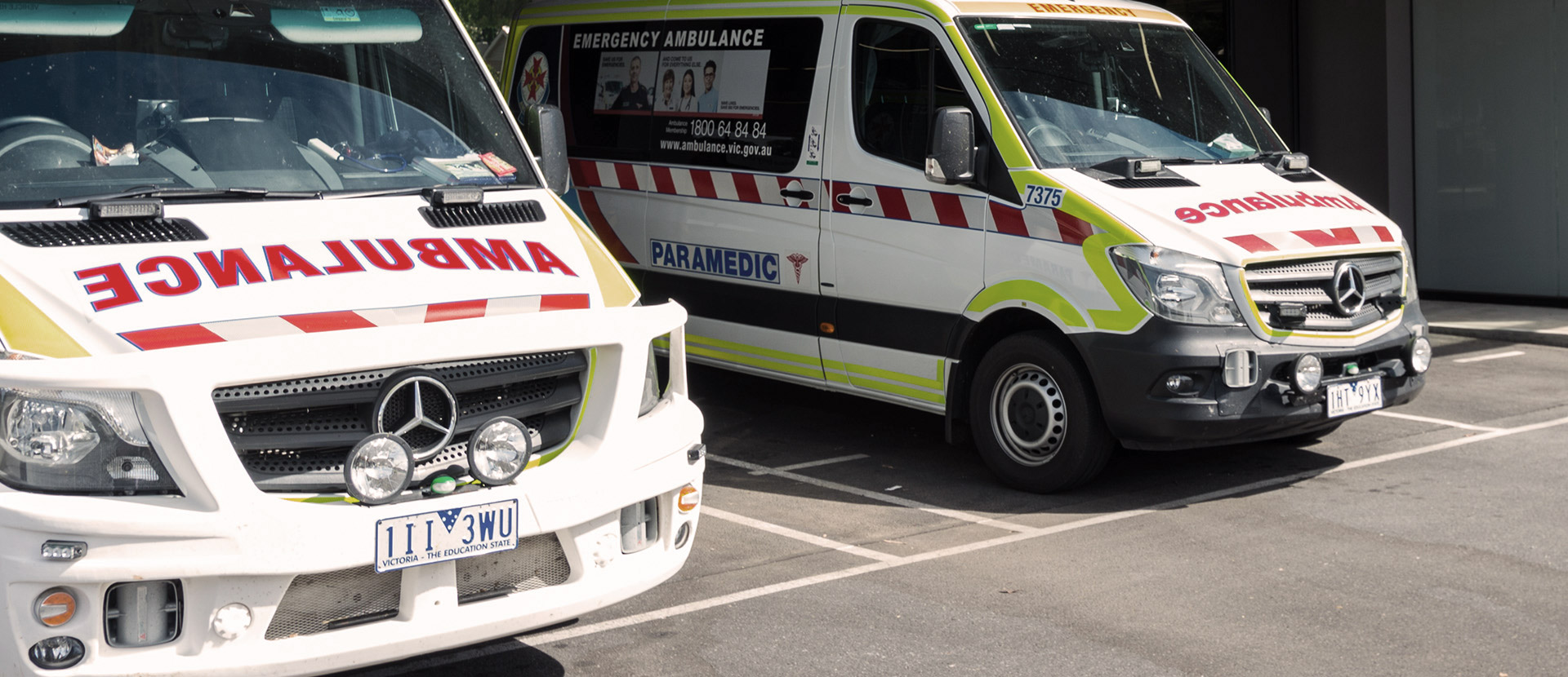 Two ambulances parked in a hospital carpark.